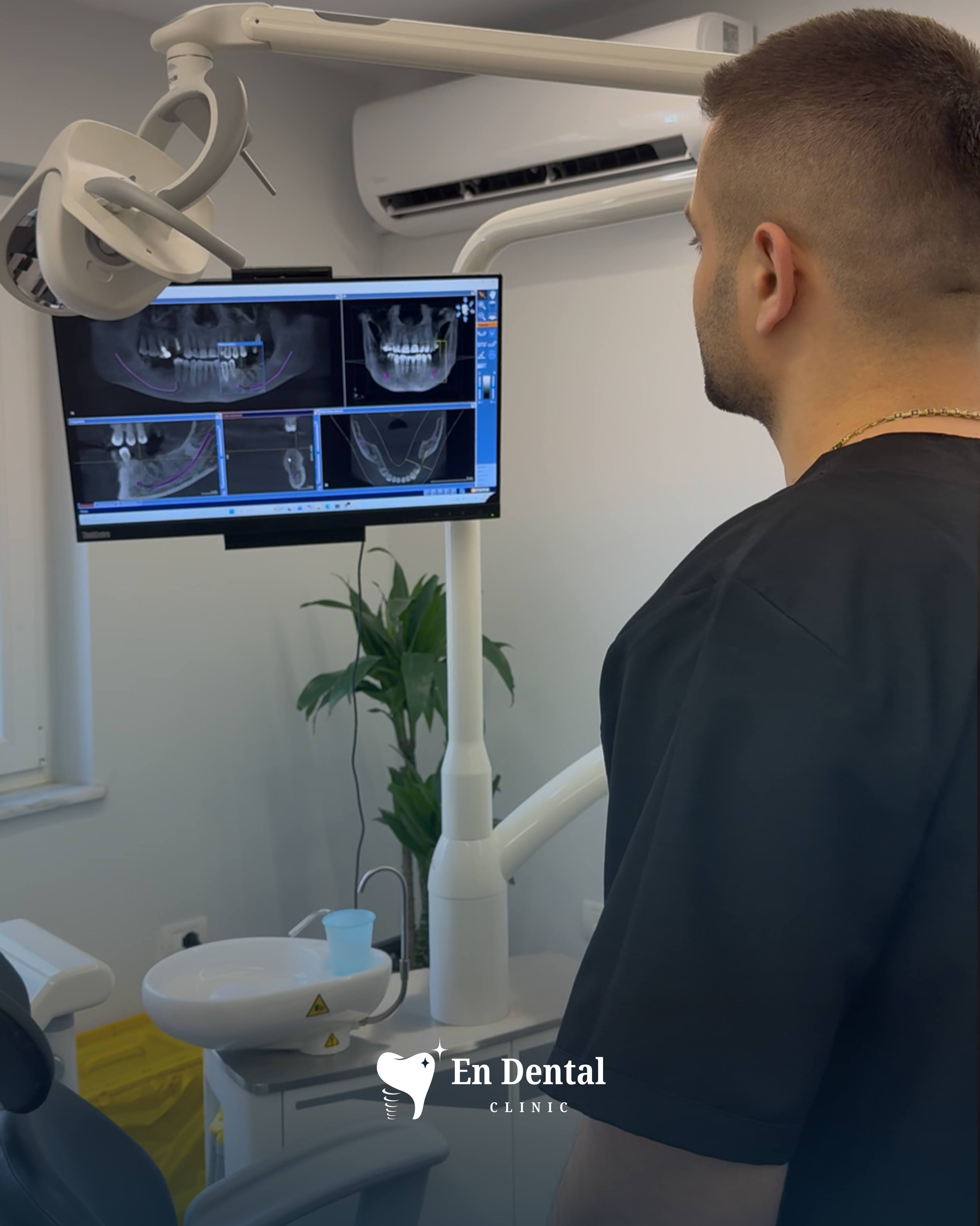 Dentist reviewing X-rays at En Dental Clinic